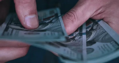 Close-up male hands of a worker counting dollar bills salary for the work Stock Footage 231195906