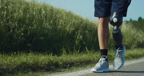 Close Up of Male Legs with Bionic Prosthetic Limb Walking Stock Footage 229691607