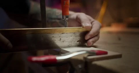 Close up of male master carpenter hands sawing wooden plank fixed with clamp on Stock Footage 137244560