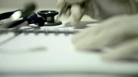 A close up of a male physician's hand writing out a prescription close up of Stock-Footage 336587629