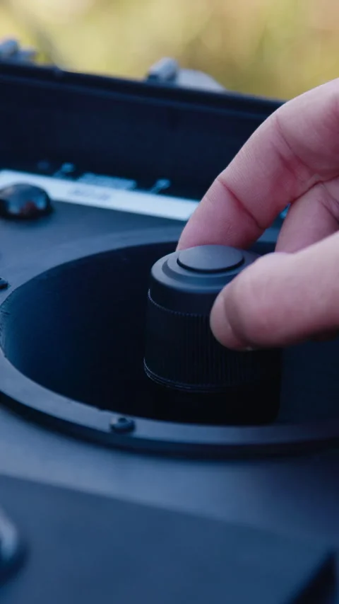 Close-up of a male pilot piloting a drone remotely from a handheld computer in a Stock Footage 314307066