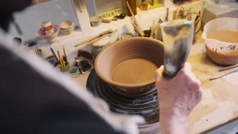 Close Up Of Male Potter Pattern Onto Bread Bowl In Ceramics Studio Stock Footage 134062177