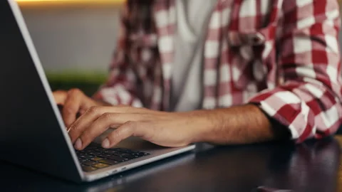 Close-up of male programmer typing on laptop, focused on a freelance project Stock Footage 313281314