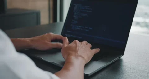 Close up male programmer whiting programmer code on his laptop computer. Digital Stock Footage 250583765