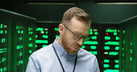 Close up of male security worker in datacenter checking work of processors with 스톡 동영상 135618984