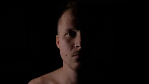 Close up of male smiling. Only half of the face is highlighted. Stock Footage 94973397