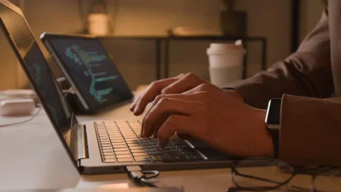 Close-up of Male Software Engineer Typing Code on Laptop Keyboard at Night Stock Footage 336715125