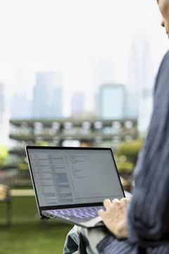 Close up of male student working with coding tech interface on laptop 스톡 사진