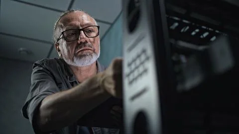 Close up of male system administrator setting up network equipment using tablet 写真素材