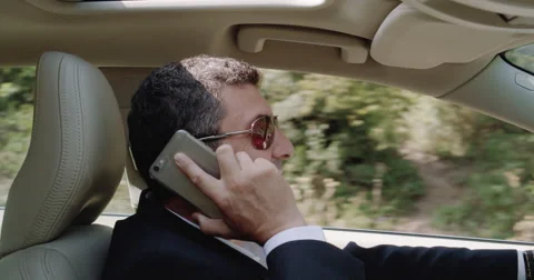 Close up of a male talking on the phone while driving the car Stock Footage 54685418