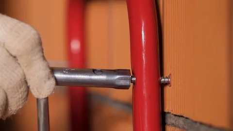 Close up of a male worker hands using socket wrench to attach metal tube to the Stock Footage 123768868