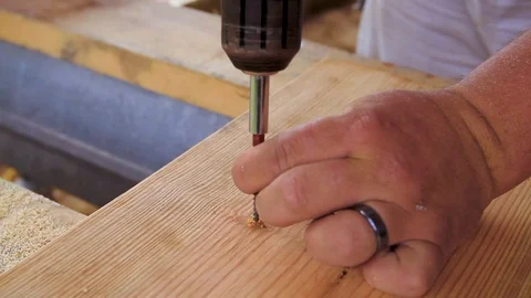 This is a close up of Males hand putting in a screw with a power drill Video stock 100801747