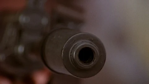 Close-up of man about to fire machine gun, 1980s Vídeos de archivo 90727951