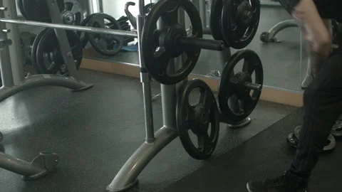 Close Up of a Man Adding Weights to a Machine at the Gym Stock Footage 233946283