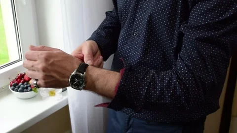 Close up of man adjusting cuff button on his stylish Stock Footage 339093123