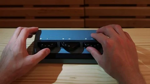 Close-up on a man adjusting volume on soviet mixing console with studio light Video stock 77409421