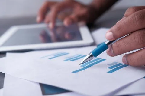 Close up of man analyzing bar chart on paper Foto stock
