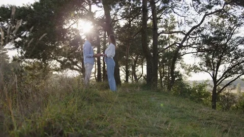 Close-up of man and a wooman that joining hands together on nature background 스톡 동영상 166467561