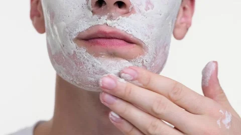 Close up of Man Applying Cream Mask on White Background Stock Footage 254517331