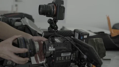 Close up of man assembling lense on filming camera setup, Portugal Stock Footage 129068773