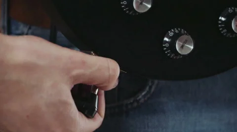Close up man attach jack connector to electric guitar Stock Footage 59194166