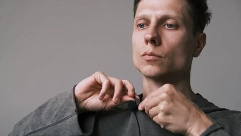 Close up of man attaching lavalier microphone to his clothes. Preparing to Stock Footage 312099362