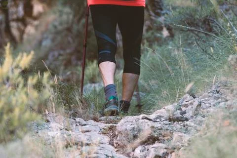Close-up of a man from the back doing hiking going up the mountain Stock Photos