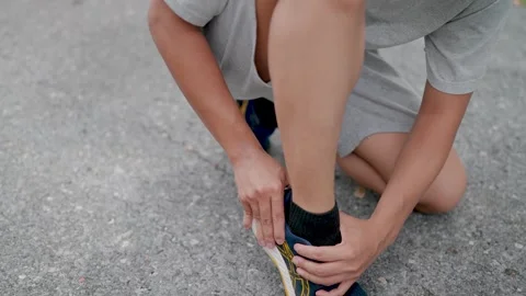 Close-up Man with back pain after jogging, Ankle massagee, Stock Footage 283187041