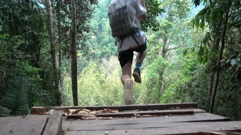 Close-Up Man With Backpack Zip Lining In Forest During Getaway Vacation - Huay Video stock 166268129