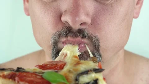Close-up, a man with a beard and moustache eating pizza, 4K Stock Footage 145109268
