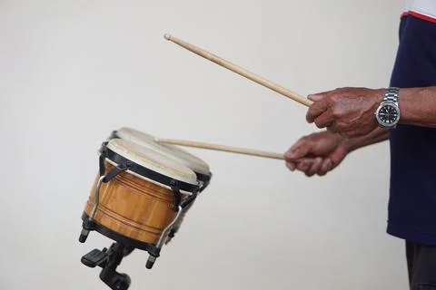 Close up man is beating the bongo drums. Concept, musical percussion instrument  Stock Photos