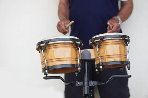Close up man is beating the bongo drums. Concept, musical percussion instrument  Stock Photos