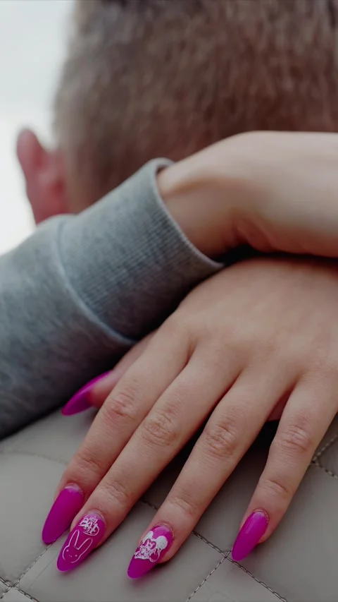 Close up of man in beige quilted jacket from behind as woman hands with bright Stock Footage 346235672