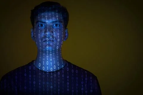 Close-up of a man with binary code reflected on his face Foto stock