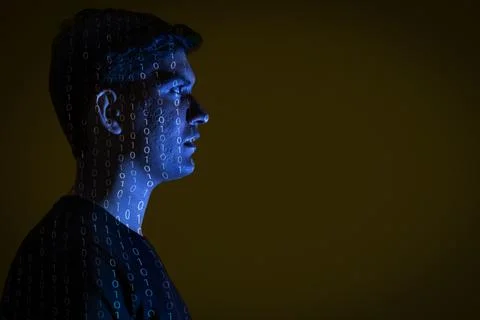 Close-up of a man with binary code reflected on his face Stock Photos