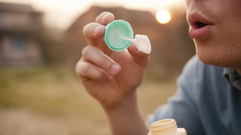 Close-up of man blowing bubbles in slow motion Stock Footage 127983813