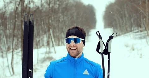 Close-up of a man in blue ski goggles. Athlete in a winter forest. Stock Footage 294685589