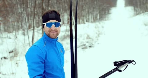 Close-up of a man in blue ski goggles. Athlete in a winter forest. Stock Footage 294685636