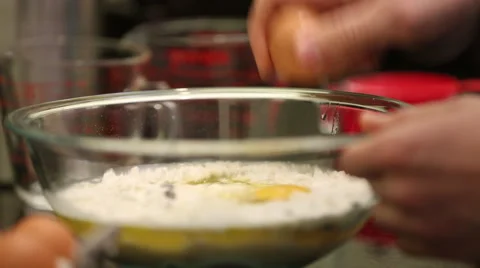 Close up of man breaking egg into mixing bowl 2 Stock Footage 61351020