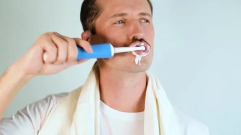 Close-up man  brushes teeth.  Daily hygiene and health care procedure. Stock-Footage 165855463