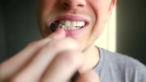 Close up of a man brushing his teeth with a toothbrush 스톡 동영상 337831075
