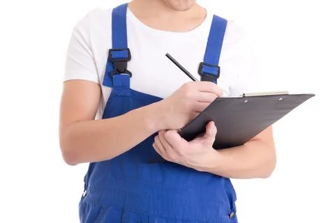 Close up of man builder in blue uniform writing something in clipboard isolat Stock Photos