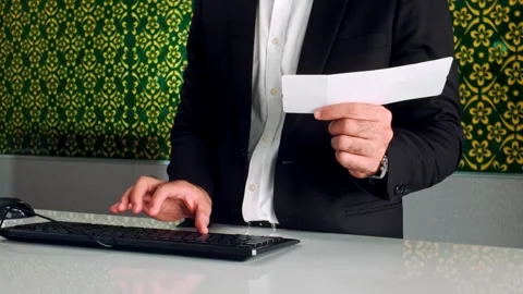 Close-up of a man in a business suit checking flight details on a computer. Video stock 311152859