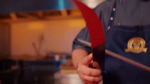 Close up of man butcher sharpens knife on professional sharpener. Stock Footage 295258910