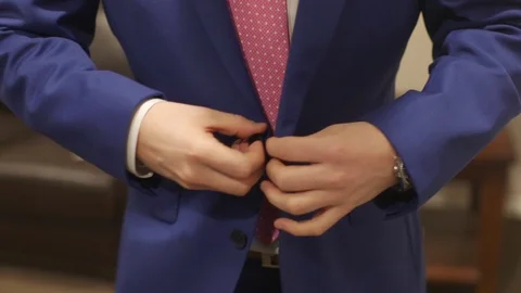 Close Up of Man Buttoning Blue Sport Coat in Pink Tie Stock Footage 99435570