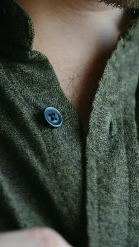 Close up of a man buttoning his shirt getting dressed Stock Footage 337893561