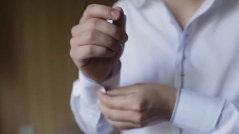 Close-up of Man Buttoning Shirt Sleeves Before Dressing Stock Footage 301424568