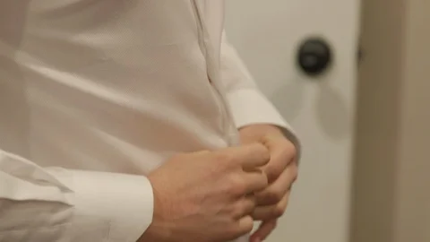 Close Up of Man Buttoning White Dress Shirt with Hands Stock Footage 99435341