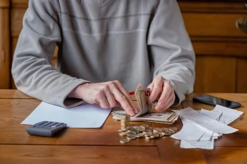 Close up man with calculator counting, making notes at home, hand is writes i Stock Photos