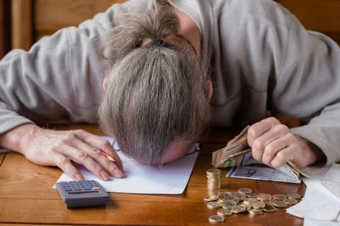 Close up man with calculator counting, making notes at home, hand is writes i Stock Photos